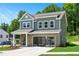 Two-story home with brick and siding, features a two-car garage and well-maintained landscaping at 134 Beacon Dr, Pittsboro, NC 27312