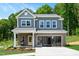 Charming two-story home featuring a brick facade, welcoming front porch, and well-maintained landscaping at 134 Beacon Dr, Pittsboro, NC 27312