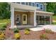 Charming front porch with brick accents, a yellow door, and a cozy seating area at 134 Beacon Dr, Pittsboro, NC 27312