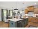 Open-concept kitchen with island, stainless steel appliances, and a view of the adjacent dining area at 134 Beacon Dr, Pittsboro, NC 27312