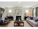 Comfortable living room with a fireplace, ample seating, and lots of natural light at 134 Beacon Dr, Pittsboro, NC 27312