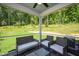 Serene screened porch with comfortable seating and views of the lush, green backyard at 134 Beacon Dr, Pittsboro, NC 27312
