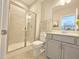 Modern bathroom with tiled shower, vanity with sink, and neutral color scheme at 1412 Queen Trigger Dr, Fuquay Varina, NC 27526