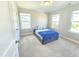 Bedroom with plush carpeting, three windows, and a comfortable bed with stylish throw pillows at 1412 Queen Trigger Dr, Fuquay Varina, NC 27526