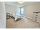 Bright bedroom with neutral carpet, a comfortable bed, and a dresser for ample storage at 1412 Queen Trigger Dr, Fuquay Varina, NC 27526