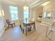 Elegant dining room featuring a modern chandelier, sleek furniture, and an open transition to the foyer at 1412 Queen Trigger Dr, Fuquay Varina, NC 27526