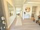 Bright foyer with stylish decor, featuring a console table, modern art, and a view into the adjoining dining area at 1412 Queen Trigger Dr, Fuquay Varina, NC 27526