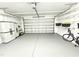 Spacious garage with epoxy floor and plenty of shelving space for organization at 1412 Queen Trigger Dr, Fuquay Varina, NC 27526