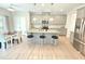 Bright kitchen featuring stainless steel appliances, granite countertops, a large island, and a breakfast nook at 1412 Queen Trigger Dr, Fuquay Varina, NC 27526