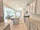 Modern kitchen with stainless steel appliances, granite countertops, and a view into the adjacent living room at 1412 Queen Trigger Dr, Fuquay Varina, NC 27526