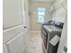 Bright laundry room features modern washer and dryer, shelving, and natural light from the window at 1412 Queen Trigger Dr, Fuquay Varina, NC 27526