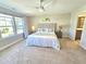 Comfortable main bedroom with a ceiling fan, carpet floors, and an ensuite bathroom at 1412 Queen Trigger Dr, Fuquay Varina, NC 27526