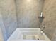 Close up shot of the tiled shower featuring a shelf and modern fixtures at 1412 Queen Trigger Dr, Fuquay Varina, NC 27526
