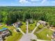 Aerial view of multiple homes nestled in a wooded community with lush greenery at 153 Hickory Nut Dr, Smithfield, NC 27577