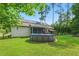 Backyard view featuring a pool, solar panels, covered patio, and screened-in porch at 153 Hickory Nut Dr, Smithfield, NC 27577