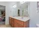 Bathroom with a double sink vanity, large mirror, walk-in shower, and an attached bedroom at 153 Hickory Nut Dr, Smithfield, NC 27577