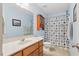 Bright bathroom with a vanity, toilet, shower/tub combo, and decorative cabinet at 153 Hickory Nut Dr, Smithfield, NC 27577
