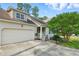 Charming home with a front-facing garage, dormer window, and covered entry at 153 Hickory Nut Dr, Smithfield, NC 27577