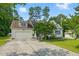 Charming home featuring a spacious driveway, two-car garage, manicured lawn, and inviting curb appeal at 153 Hickory Nut Dr, Smithfield, NC 27577