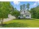 Beautiful one-story home featuring a spacious driveway, two-car garage, manicured lawn, and American flag at 153 Hickory Nut Dr, Smithfield, NC 27577
