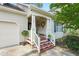 Charming front porch decorated with plants and wreath enhancing the entrance's inviting appeal at 153 Hickory Nut Dr, Smithfield, NC 27577