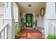 Charming front porch decorated with plants, bench, and wreath enhancing the entrance's inviting appeal at 153 Hickory Nut Dr, Smithfield, NC 27577
