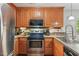 Traditional-style kitchen featuring wood cabinets and stainless steel appliances, including microwave, oven and refrigerator at 153 Hickory Nut Dr, Smithfield, NC 27577