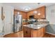 Traditional kitchen features wood cabinets, stainless appliances and a peninsula with a stainless steel sink at 153 Hickory Nut Dr, Smithfield, NC 27577