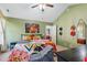 Vibrant main bedroom with green walls, colorful bedding, and a ceiling fan at 153 Hickory Nut Dr, Smithfield, NC 27577