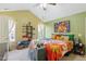 Bright main bedroom with a vaulted ceiling, colorful bedding, and a large window at 153 Hickory Nut Dr, Smithfield, NC 27577