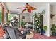 Inviting screened porch with wicker furniture, plants, and a ceiling fan at 153 Hickory Nut Dr, Smithfield, NC 27577
