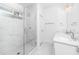 Bright bathroom featuring a glass enclosed shower, dual vanity with white cabinets and marble countertops and tiling at 1621 Ella Wiggins Way, Raleigh, NC 27603