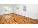 Bright bedroom with hardwood floors, white walls, and ample natural light from several windows at 1621 Ella Wiggins Way, Raleigh, NC 27603