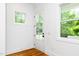 Bright entryway featuring hardwood floors, white walls, natural light, and a glass panel door at 1621 Ella Wiggins Way, Raleigh, NC 27603