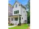 Charming two-story home with a welcoming front porch, black trim windows and a well-manicured lawn at 1621 Ella Wiggins Way, Raleigh, NC 27603
