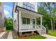 Inviting front porch featuring classic white railings, wooden steps, and a view of the manicured lawn at 1621 Ella Wiggins Way, Raleigh, NC 27603