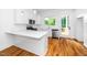 Bright, white kitchen features quartz countertops, stainless steel appliances, and hardwood floors at 1621 Ella Wiggins Way, Raleigh, NC 27603