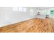 Spacious living room featuring hardwood floors, white walls, large windows and an open concept design at 1621 Ella Wiggins Way, Raleigh, NC 27603