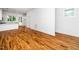 Bright, open-concept living room with hardwood floors, white walls, and large windows for ample natural light at 1621 Ella Wiggins Way, Raleigh, NC 27603