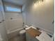 Bright bathroom featuring white tub and vanity, complete with a shower head and sleek lighting at 165 Tee Dr, Selma, NC 27576