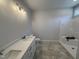 Bathroom featuring a double vanity, tile floor, and shower at 165 Tee Dr, Selma, NC 27576