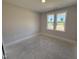 Bedroom with natural light from the two large windows at 165 Tee Dr, Selma, NC 27576