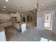Bright, open kitchen with island, white cabinets, and stainless steel appliances at 165 Tee Dr, Selma, NC 27576