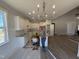 Modern kitchen with white cabinets, granite countertops, stainless steel appliances, pendant lighting, and an open concept layout at 165 Tee Dr, Selma, NC 27576