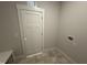 Tiled laundry room with washer and dryer hookups at 165 Tee Dr, Selma, NC 27576