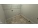The laundry room features tiled floors, washer and dryer hookups, and overhead storage at 165 Tee Dr, Selma, NC 27576