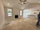 Spacious living room with vaulted ceiling, fireplace, and views of kitchen at 165 Tee Dr, Selma, NC 27576