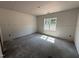 Well-lit bedroom with a large window, creating a serene and inviting atmosphere, ready to be transformed at 183 Tee Dr, Selma, NC 27576