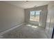 Bedroom with large window, freshly painted, and prepped for flooring, offering a bright and clean space at 183 Tee Dr, Selma, NC 27576