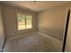 Clean and bright bedroom features fresh paint and a window framing a green outdoor view at 183 Tee Dr, Selma, NC 27576